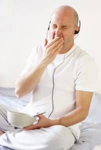 Yawning man with headphones - he needs sleep therapy!